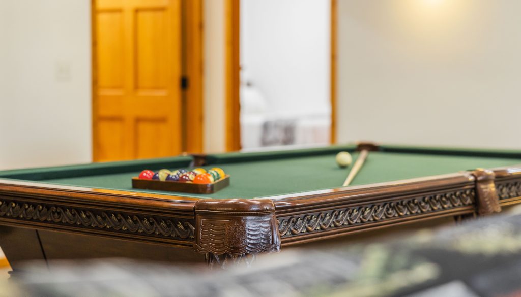 Billiard balls and cue stick on pool table