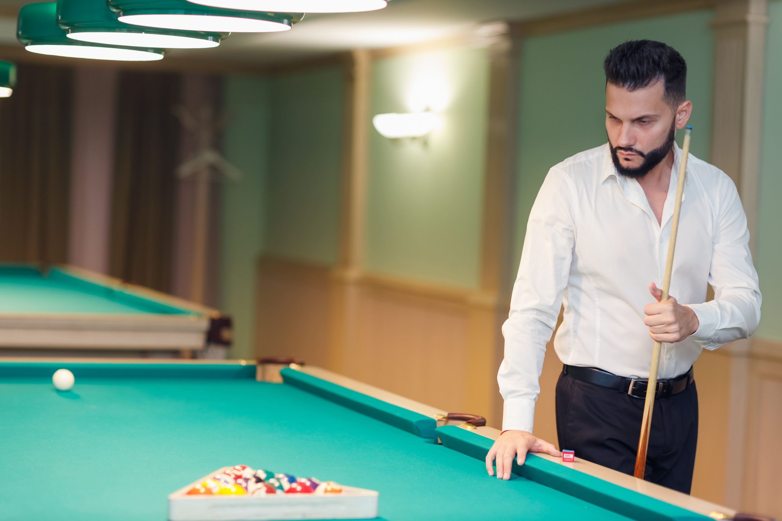 Billiard player at billard table or snooker american billiards pool sport game Billiard player at billard table or snooker american billiards pool sport game