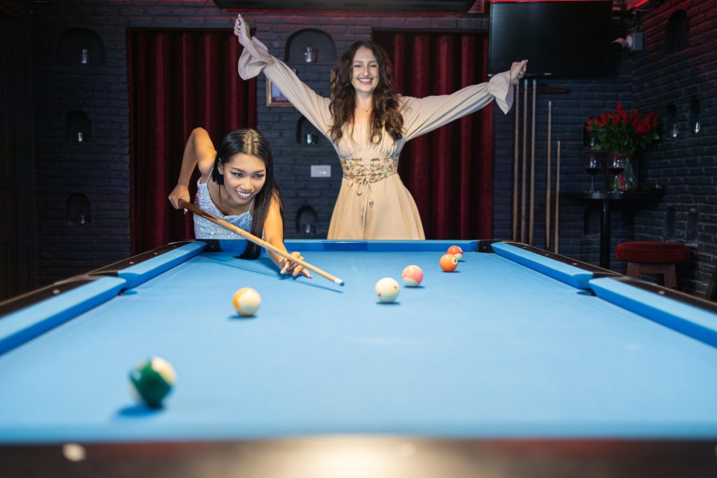 Friends Playing Pool at Vibrant Nightclub