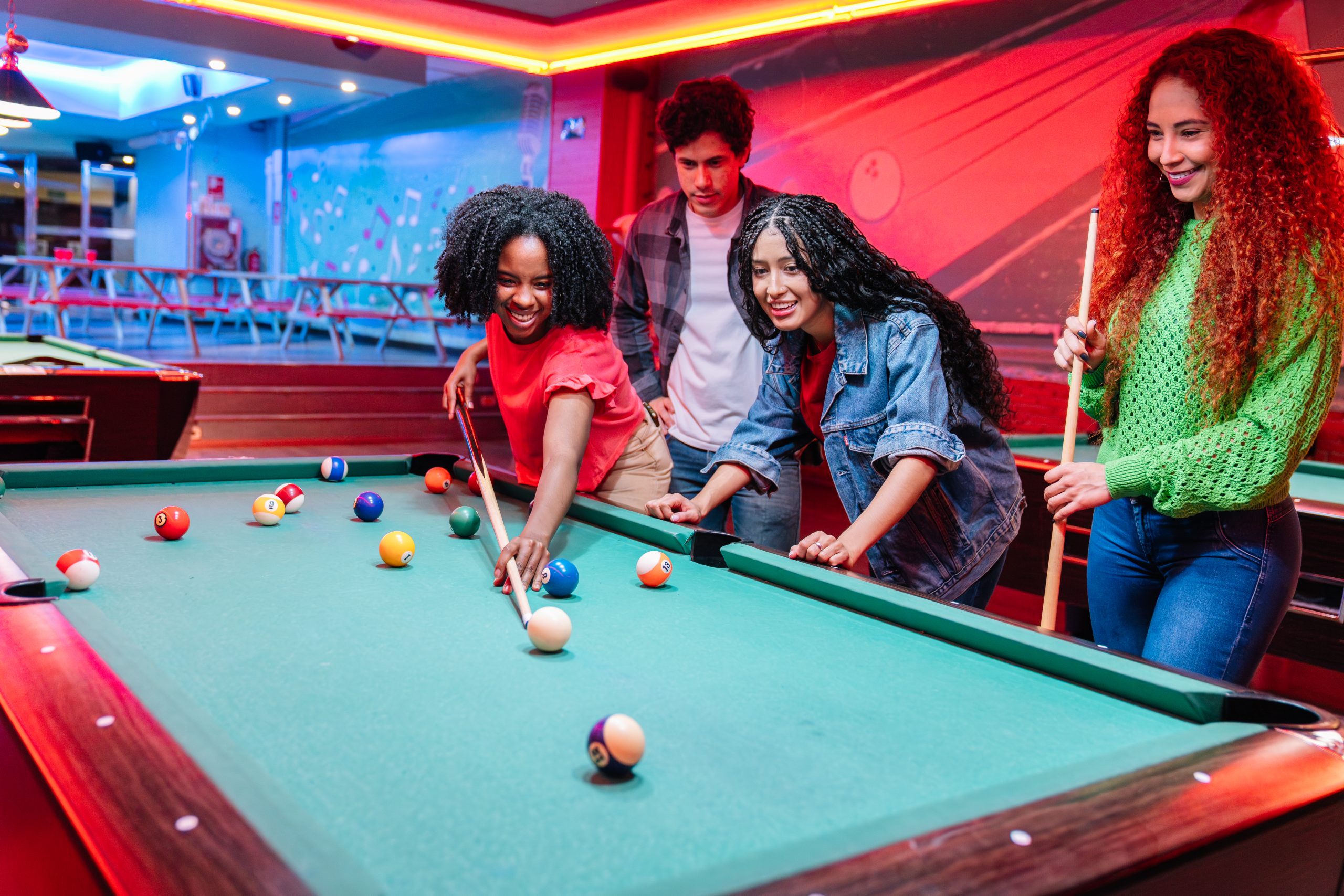 Friends playing billiards in an entertainment venue
