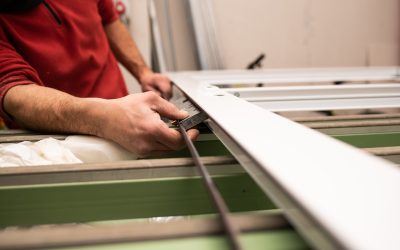 Male with a red shirt making a window with industrial tools