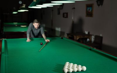 Man playing in Russian billiard at bar