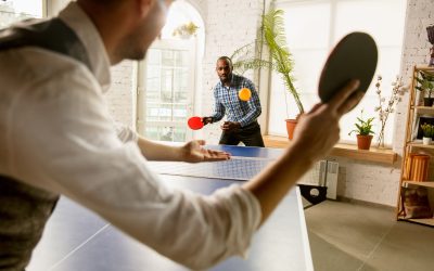 Men Playing Table Tennis in a Bright Room