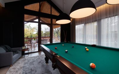 modern billiard room with a beautiful table and large windows