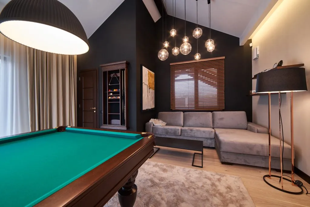 modern billiard room with a beautiful table and large windows